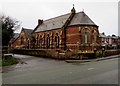 Fenced-off former church and school in Pentre Ffwrndan, Oakenholt in CH6 5GJ