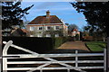 White gate and house at Chisbury in SN8 3JA
