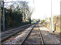A tram approaches Merton Park Tramstop in SW19 3EN