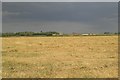 Across stubble towards control tower of former RAF West Raynham in NR21 7DP