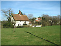 Houses adjacent to the playing field in Quidenham in NR16 2NZ