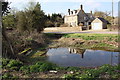 Pond beside Burford Road opposite Brook House in OX18 3NP