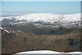 Lone walker approaching summit of Birks in Patterdale