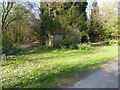 Wooden building at fork in footpath in GU6 7SW