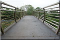 View of the footbridge over the Roding in Roding Valley Park in IG4 5BD