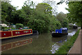Grand Union Canal. A working boat goes by. in MK12 5PN