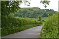 View down Stonehill with South Cadbury Castle in the distance in BA22 7HG