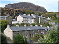 Double row of houses with mountain behind in LL41 3TW