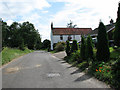 Southeast past houses on Tithe Barn Lane in Briston Ward