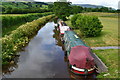 Narrowboats moored below Monmouthshire and Brecon Canal bridge No. 159 in LD3 7LJ