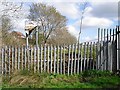Fence and old sign at former landfill site in CA1 2UF