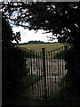 View south through the churchyard gate in NR13 6NN