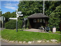 Bus shelter, phone box, rubbish bin and signpost at Edington in TA7 9LF