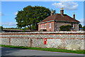 Flint wall and house, with postbox, Chilcomb in SO21 1HR