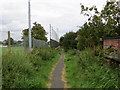 Enclosed pathway between housing and sports ground at Emley in HD8 9RB