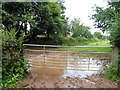 Muddy gateway at Dunscombe Farm in EX5 5AX