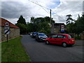 Cars parked at the lane junction in SN15 2PZ