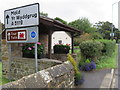 Bus shelter and a stone in the hedge in Northop in CH7 6AY