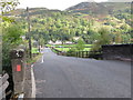 Road to A91 crossing bridge over former railway line at Menstrie in FK11 7HW