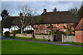 Thatched cottages by the green at Urchfont in SN10 4RA