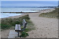 Bench and beach with Poole Bay beyond in BH6 4BY