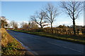 Looking east up the A1094 at the drive to Park Farm in Friston