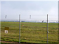 Through the airport fence in CM24 1QJ