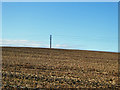 Power line across brown field in SP4 9RJ