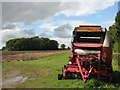 Baler parked in corner of ploughed field in Salle