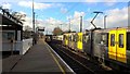 Newcastle Airport Metro trains cross at Kenton Bankfoot station in NE13 8AG