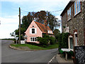 Pink cottage on junction of Hindringham Road with Warham Road in Binham