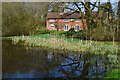 Pond and house at Lasham in GU34 5SG