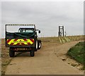 Highway maintenance tractor parked on farm track in NR13 6ND
