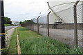Flowers and storage tanks on Trafford Wharf Road in M50 1DL