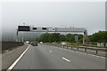 Motorway gantry over M4 near junction 40 in SA13 1YR