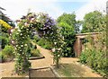Flowering shrub arch in Stow Hall Gardens, Norfolk in PE34 3HS