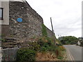Wall with blue plaque in Trearddur