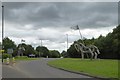 Sculpted horse and rider facing a horse, Stonehills Roundabout in GL20 7BX