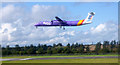 Flybe aircraft landing at Edinburgh Airport in EH12 0AN