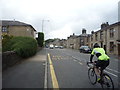 Bus stop and cyclist on Blackburn Road (A666) in BL7 9SR