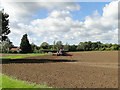 Tractor cultivating the soil ready for drilling in Hasketon