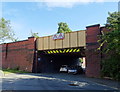 Railway bridge over Joshua Lane in M24 2TS