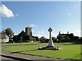 Caston War Memorial and church across The Green in NR17 1DE