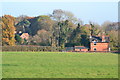 Houses seen across field at Old Burghclere in RG20 9NR