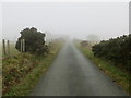 Fenced minor road heading towards Pen-y-bryn in LL15 2DS