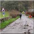 Cyclist heading towards a very steep ascent, Llangenny, Powys in NP8 1TL
