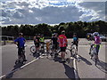Cyclists resting at the entrance to Chepstow racecourse car park in NP16 5LT