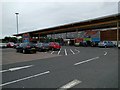 Tesco and its car park in DG12 6QR
