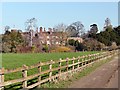 View across a fenced field to Hodsock Priory and Gardens in Hodsock
