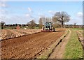 A farmer harrowing his field in NR13 5AP